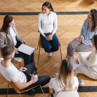 medium-shot-people-sitting-circle_23-2148913058