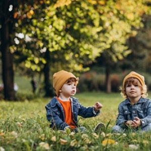 two-boys-brothers-sitting-grass-tree_1303-25297 (1)